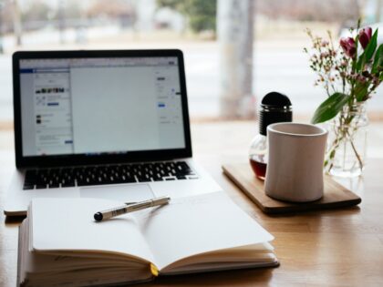 Image of a notebook, laptop and mug by Nick Morrison on Unslpash